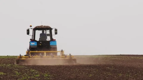 A tractor plows a field in the spring. Stock Footage 274164923