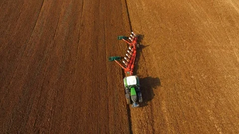 Tractor plows a field in spring -Tractor cultivating a field - Aerial view - 4K Stock Footage 88466587