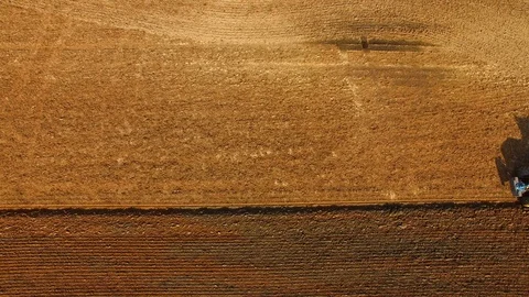 Tractor plows a field in spring -Tractor cultivating a field - Aerial view Stock Footage 88504318