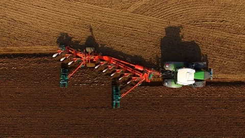 Tractor plows a field in spring -Tractor cultivating a field - Aerial view Stock Footage 88518216