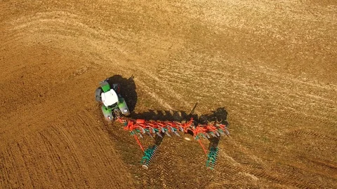 Tractor plows a field in spring -Tractor cultivating a field - Aerial view Stock Footage 88520767