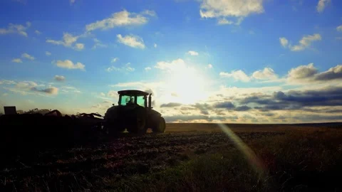Tractor plows the field at sunset. Land cultivation after wheat harvest. Stock Footage 202044206