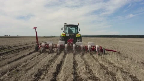 Tractor plows a field of wheat Video stock 209933634