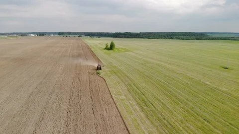Tractor plows fields in the spring. Beautiful landscape from above Video stock 116249151