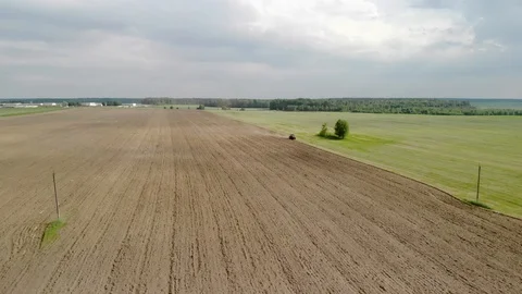 Tractor plows fields in the spring. Beautiful landscape from above Stock-Footage 117288766