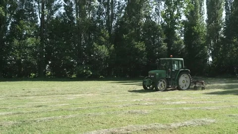 Tractor plows the grassy field Stock Footage 271195788
