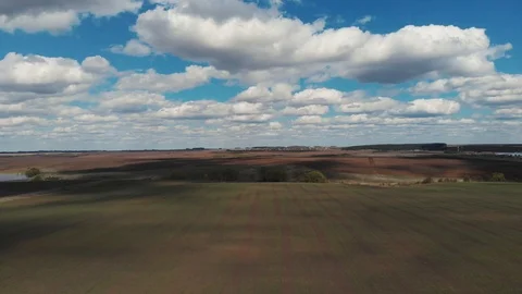The tractor plows the ground on the field at the beginning of the planting Stock Footage 107495327