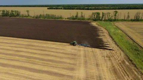 A Tractor Plows a Harvested Corn Field for Future Planting. View From Above Stock Footage 127636039