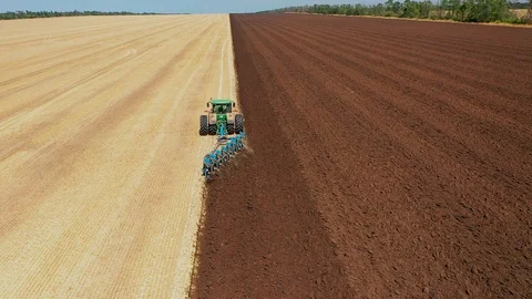 A Tractor Plows a Harvested Corn Field for Future Planting. View From Above Stock Footage 127636928