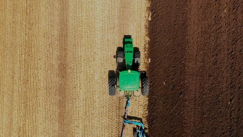 A Tractor Plows a Harvested Corn Field for Future Planting. View From Above Stock Footage 127637803