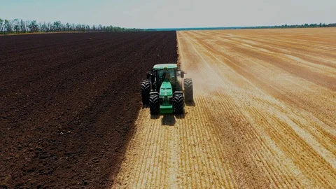 A Tractor Plows a Harvested Corn Field for Future Planting. View From Above Stock Footage 127638887