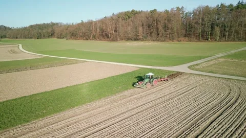 Tractor plows the land in spring, aerial view Stock Footage 341125484