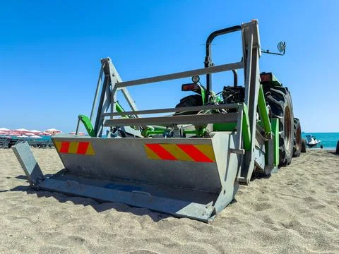 Tractor preparing the beach for visitors on a sunny day Stock Photos
