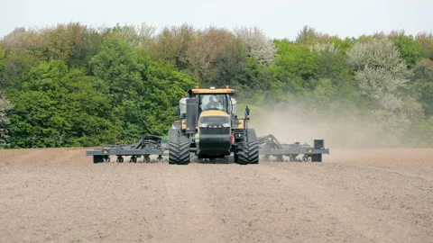 Tractor Preparing Field for Planting, A large tractor equipped with farming Stock Footage 280904236