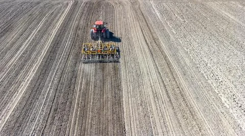 Tractor preparing field at spring Stock Photos