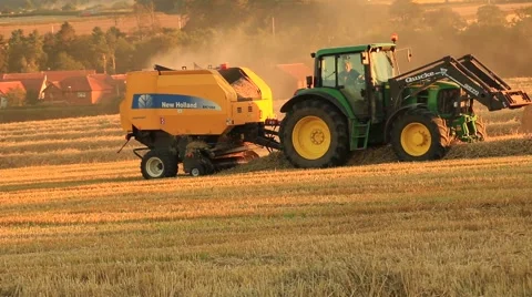 Tractor preparing hay bales on a wagon Stock Footage 41755576