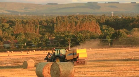 Tractor preparing hay bales on a wagon Stock Footage 41756262