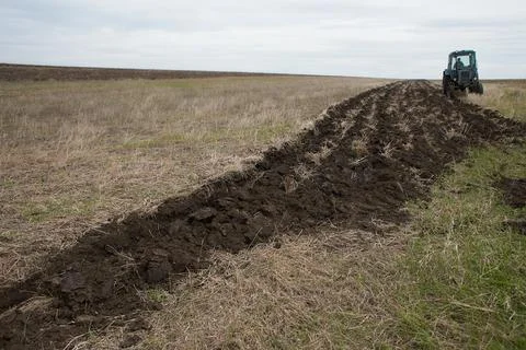 Tractor preparing land for sowing Stock Photos