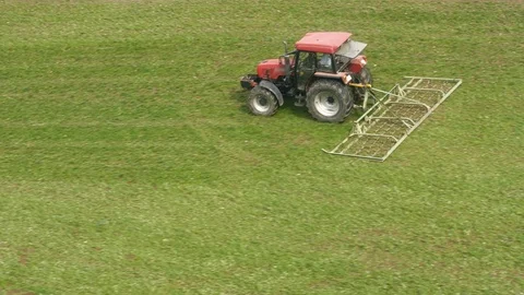 Tractor preparing meadow scene depicting agriculture Stock Footage 89155899