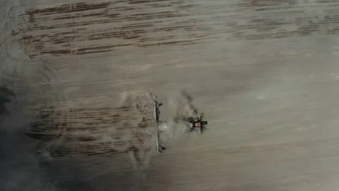 Tractor that processes dusty, low-yielding agricultural land using a tillage Stock Footage 134041542