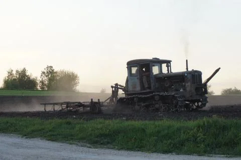 The tractor processes the field Stock Photos