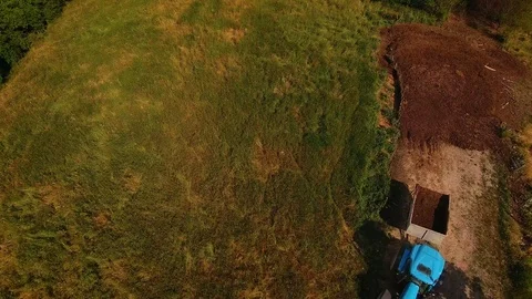 Tractor puling trailer on grassy field   Stock Footage 112175174