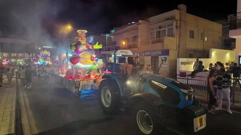 Tractor-Pulled Carnival Float with a Colorful Theme at Malta Summer Carnival Stock Footage 303573139