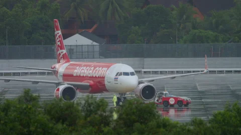 Tractor pulling airplane AirAsia Stock Footage 274528424
