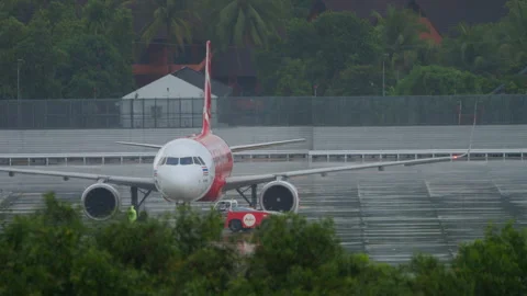 Tractor pulling airplane AirAsia Stock Footage 276234290