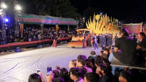 Tractor pulling car with candle at parade,Ubon Ratchathani,Candle Stock Footage 81068612