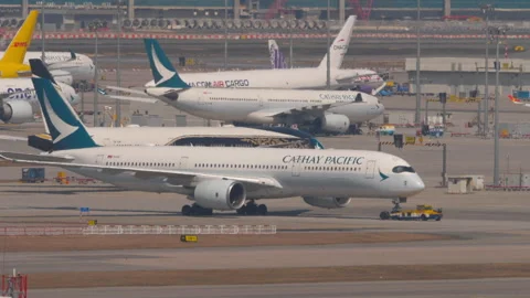Tractor pulling Cathay Pacific, side view Stock Footage 306474624