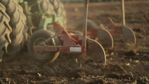 Tractor pulling Chisel drives by in Field Stock-Footage 94642773