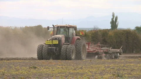 Tractor pulling cultivation implement Stock Footage 870918