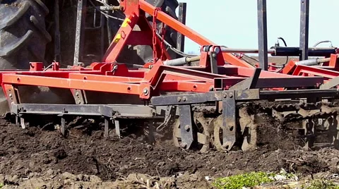Tractor pulling land cultivating machine Stock Footage 49537348