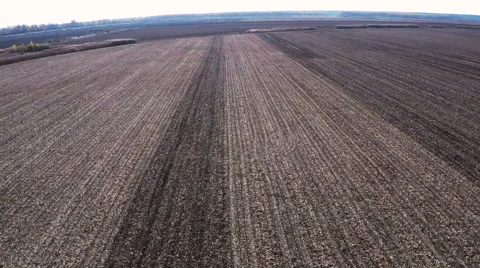 Tractor pulling land cultivating machine. Disking land. Aerial footage. Stock Footage 57375088