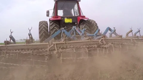 Tractor pulling land cultivating machine. Stock Footage 80044667