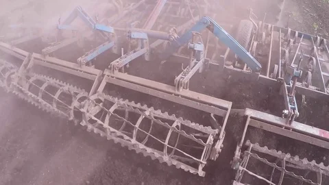 Tractor pulling land cultivating machine. Stock Footage 80045792