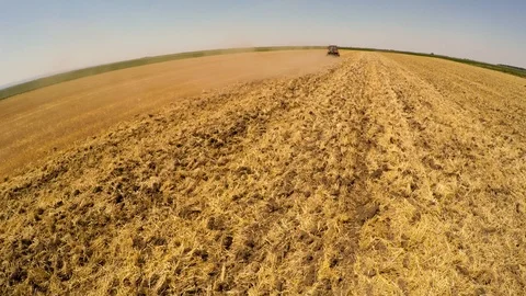 Tractor pulling land cultivating machine. Aerial footage. Stock Footage 88877402