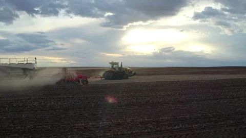 Tractor pulling Seeding Air Drill at Evening Stock Footage 263036050