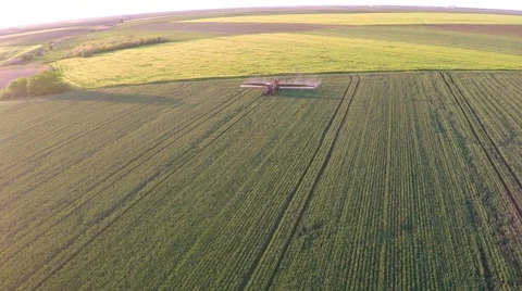 Tractor pulling a sprayer machine in wheat fields. Stock Footage 50285681