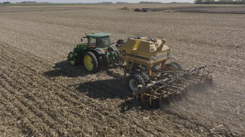 Tractor Pulling Strip Till Machine, Preparing Soil on Farm Field for Stock Footage 255563343