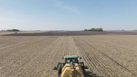 Tractor Pulling Strip Till Machine to Prepare for Seeding, Aerial Video stock 255624397