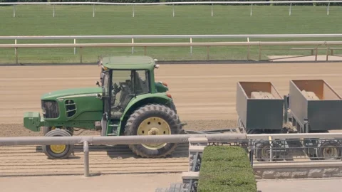 Tractor pulling Track Conditioner at horse race track in Lexington Kentucky Stock Footage 242970167