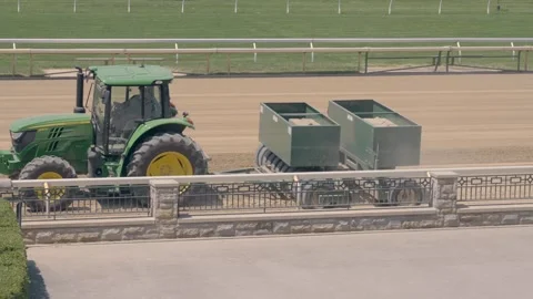 Tractor pulling Track Conditioner at horse race track in Kentucky Stock Footage 242970285