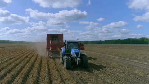Tractor pulls combine harvester on trailer Stock-Footage 93137771