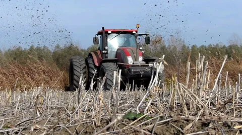 Tractor pulls a machine that cuts the channels in the field Stock Footage 48362073