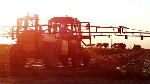 The tractor pulls a machine for spraying cucumbers. Summer sunset. Stock Footage 72197493