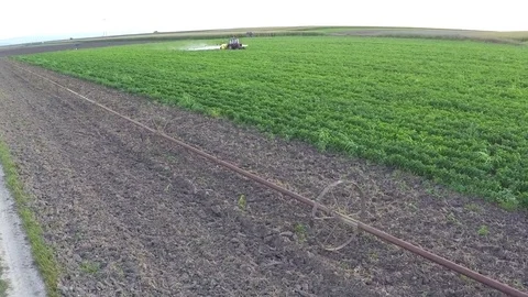The tractor pulls machine for a spraying in a field of peppers. Aerial footage. Stock Footage 72217574