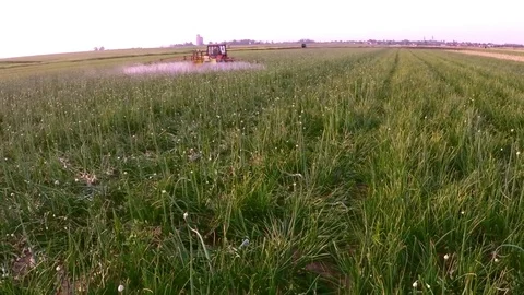 The tractor pulls a machine for spraying onion. Aerial footage. Stock Footage 83551755
