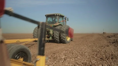Tractor pulls Massive Leveler over Soil Stock Footage 94643209